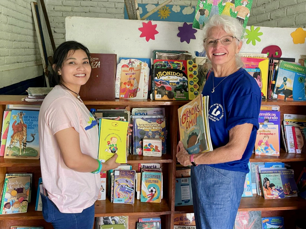 Volunteers perusing the Cebadilla Satellite Library Collection